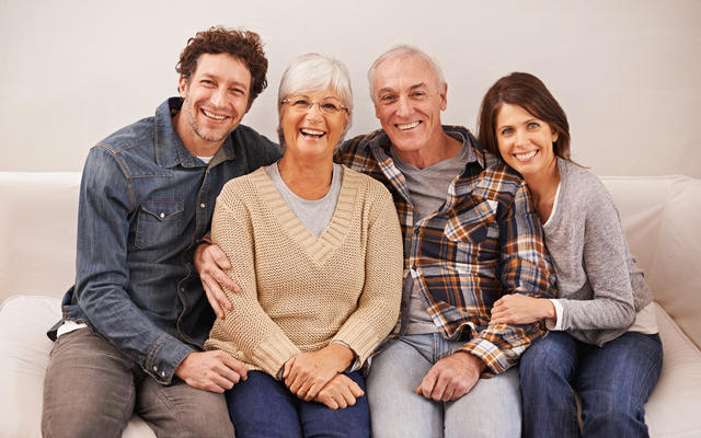 couple and senior parents on sofa